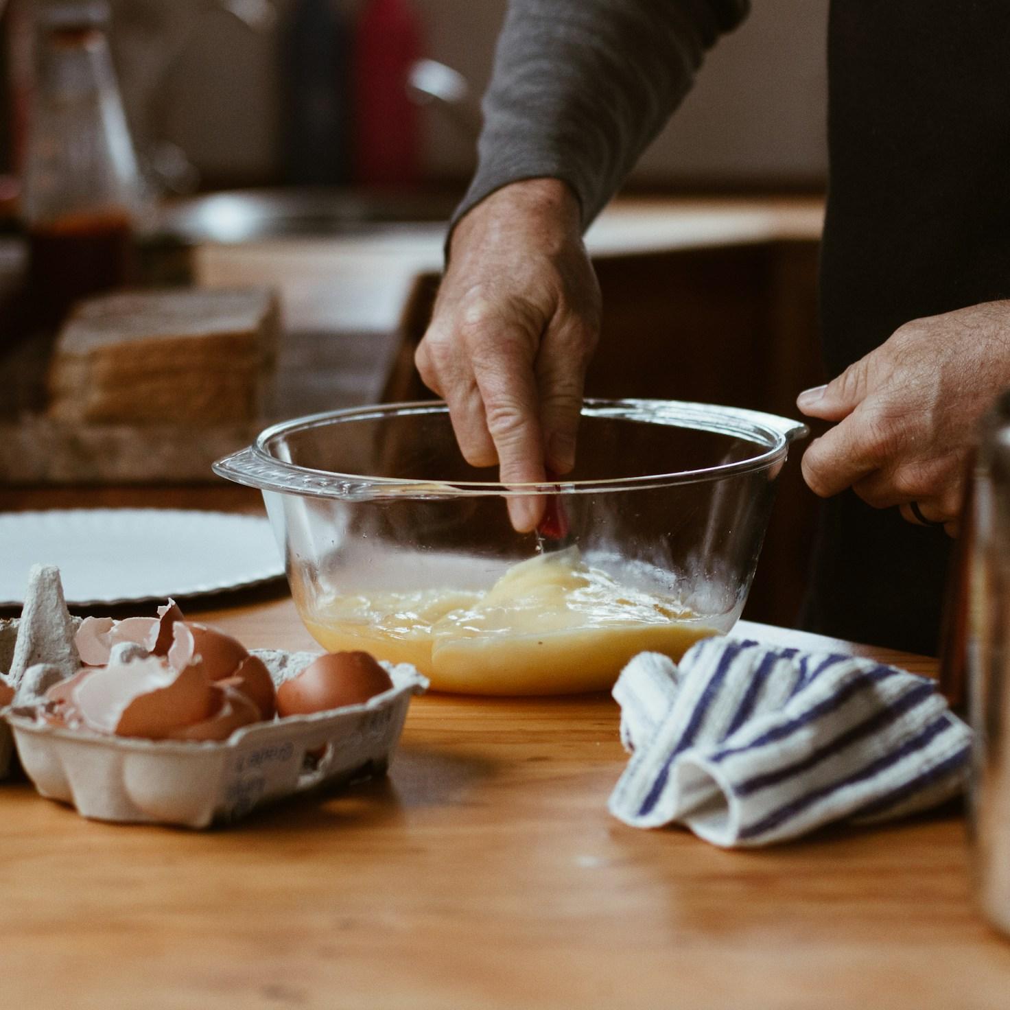 Community members collaborating in a contemporary kitchen, exchanging recipes and techniques